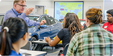 drivers ed instructor speaking with students