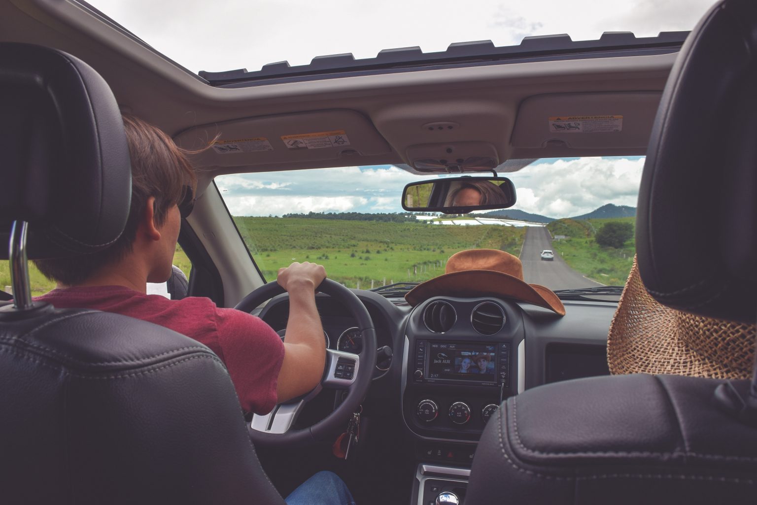 backseat view of a teen driver in Texas learning to drive