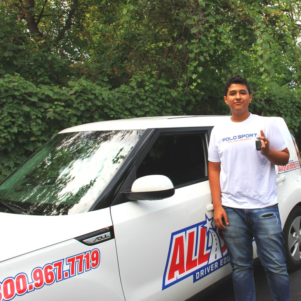 all star student next to training vehicle